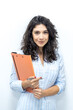 © Jake Jakab - Successful young caucasian businesswoman holding documents in office. Front view of smiling caucasian female freelancer working at home