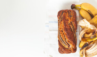 Wall Mural - Flat lay of fresh homemade banana bread on white background. healthy diet breakfast.