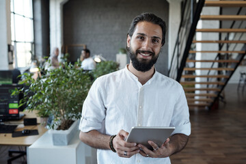 Aufkleber - Successful young Muslim businessman with digital tablet standing in office