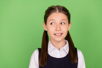 Canvas Print - Photo of charming thoughtful schoolgirl wear formal outfit smiling looking empty space isolated green color background