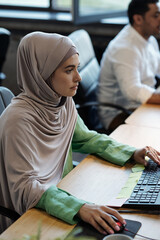 Aufkleber - Pretty Muslim businesswoman in hijab sitting in front of computer during work