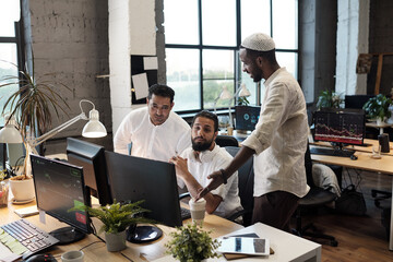 Aufkleber - Three intercultural businessmen consulting about working moments in front of computer