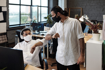 Aufkleber - Two contemporary businessmen greeting each other by elbow bump during pandemic period