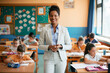 © Drazen - Happy African American elementary school teacher with her students in the classroom.