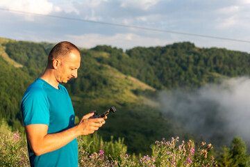 man playing with the drone. Man with flying drone. Man operating the drone by remote control and having fun.