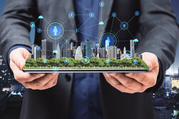 Poster - Close up of businessman hands holding tablet with abstract glowing connections globe on night city background.