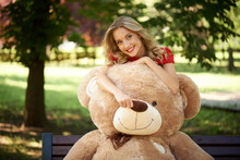 Happy Young Woman With A Huge Teddy Bear.