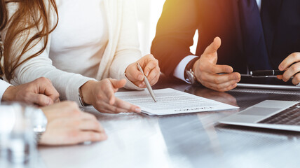 business people discussing contract while working together in sunny modern office. unknown businessm