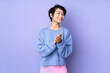 © luismolinero - Young Vietnamese woman with short hair over isolated purple background applauding after presentation in a conference