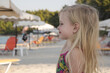 © triocean - Portrait of adorable toddler girl with long blonde hair on the beach. Happy summer time childhood concept.