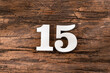 Number fifteen - White Piece on Rustic Wood Background