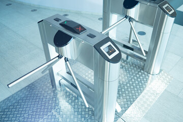 Turnstiles inside business center. Access restriction turnstiles. Concept - access to premises by passes. Restriction of entry without presenting a pass. Automatic turnstile with magnetic sensor