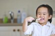 © tpap8228 - A little Chinese boy is eating breakfast with the happy face in house. Boy is sitting in the high chair