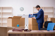 © Elnur - Young male employee in relocation concept