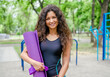 © tan4ikk - Girl with yoga mat outdoors