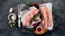 Raw Pork Belly On Dark Gray Background. Organic Gourmet Food Concept.