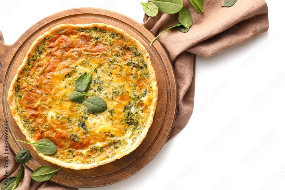 Board with tasty spinach tart on white background