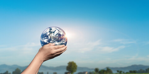 Canvas Print - hands holding globe, earth on nature sky background. elements of this image furnished by nasa