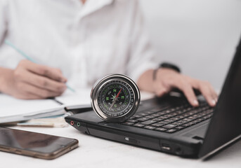 Businessman at the workplace with compass on desk