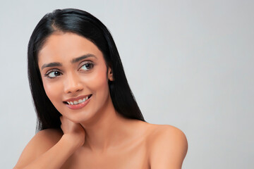 Portrait of a young woman with clear,spotless skin smiling.