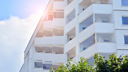 Wall Mural - Modern white facade of a residential building with large windows. View of modern designed concrete apartment building.