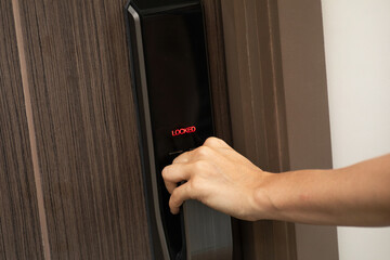 Hand and digital smart code lock into the modern apartment