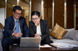 © DragonImages - Smiling senior business people watching presentation on laptop screen and discussing details of new project