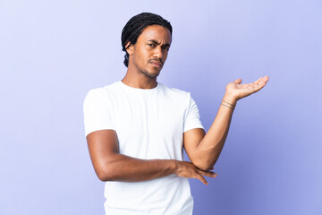 Wall Mural - Young African American man with braids man isolated on purple background having doubts