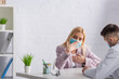 © LIGHTFIELD STUDIOS - diseased woman in medical mask coughing during appointment with physician