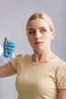 © LIGHTFIELD STUDIOS - blonde woman looking away while doctor giving her vaccine injection