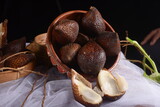 Fresh salak fruit on a dark background. Salacca zalacca, Salak fruit. A bunch of salak fruit in a fruit basket