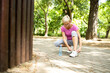 © littlewolf1989 - Senior caucasian woman tying her shoelace before jogging in the park.
