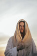 Portrait of Jesus Christ in white robe against sky.