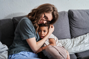 Wall Mural - Mother bonding and embracing with tenderness her little daughter