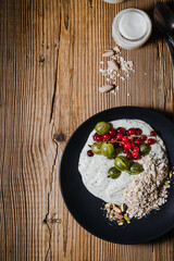 Wall Mural - Breakfast smoothie bowl with gooseberries, red currants, rolled oats, pistachios