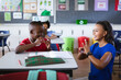 © WavebreakMediaMicro - African american female teacher and boy talking in hand sign language at elementary school