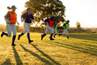 © Wavebreak Media - Diverse group of female baseball players warming up on field at sunrise, running