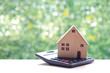 Estate tax,Model house on calculator with on natural green background,Business investment and Property tax concept