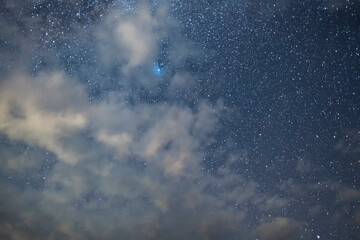 Wall Mural - starry sky and long exposhur clouds. dark night sky with clouds. astronomical background.