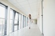 © Serhii - Young Businesswoman Standing In Corridor Of Modern Office Building