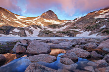 Pink Dawn Light Over Mt. Toll And Partially Frozen Blue Lake In Colorado's Indian Peaks Wilderness.