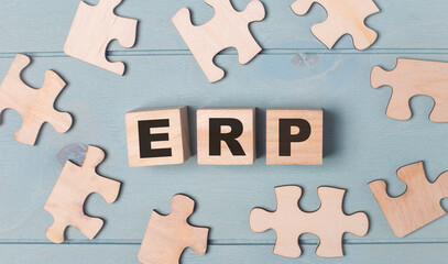 Fototapete - Blank puzzles and wooden cubes with ERP lie on a light blue background.