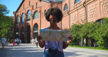 Cheerful Afro Woman Wanderer Searching Direction On Location Map Traveling Abroad In Summer