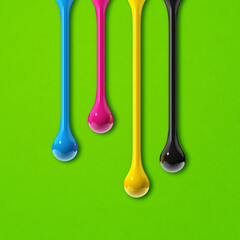 Wall Mural - cmyk ink drops on green paper square background