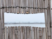 Close-up Of Wooden Fence Against Lake