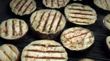 Wall Mural - Cooking eggplant in a grill pan. Healthy food without the use of oil