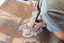 Caucasian Man Sculptor, Bush Hammering A Granite Headstone In A Workshop, Work Concept