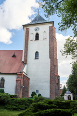 Wall Mural - Historic church with a bell tower with a clock in the city of Oborniki