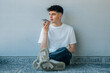 © carballo - fashionable teenage boy sending voice message with mobile phone