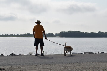 Canvas Print - Man and Dog by a River